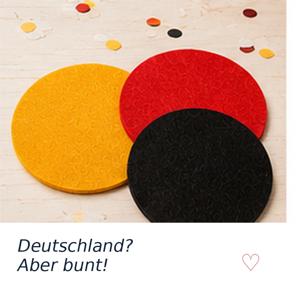 BIASTO LänderLaune Untersetzer in Schwarz, Rot und Gold auf einem Tisch